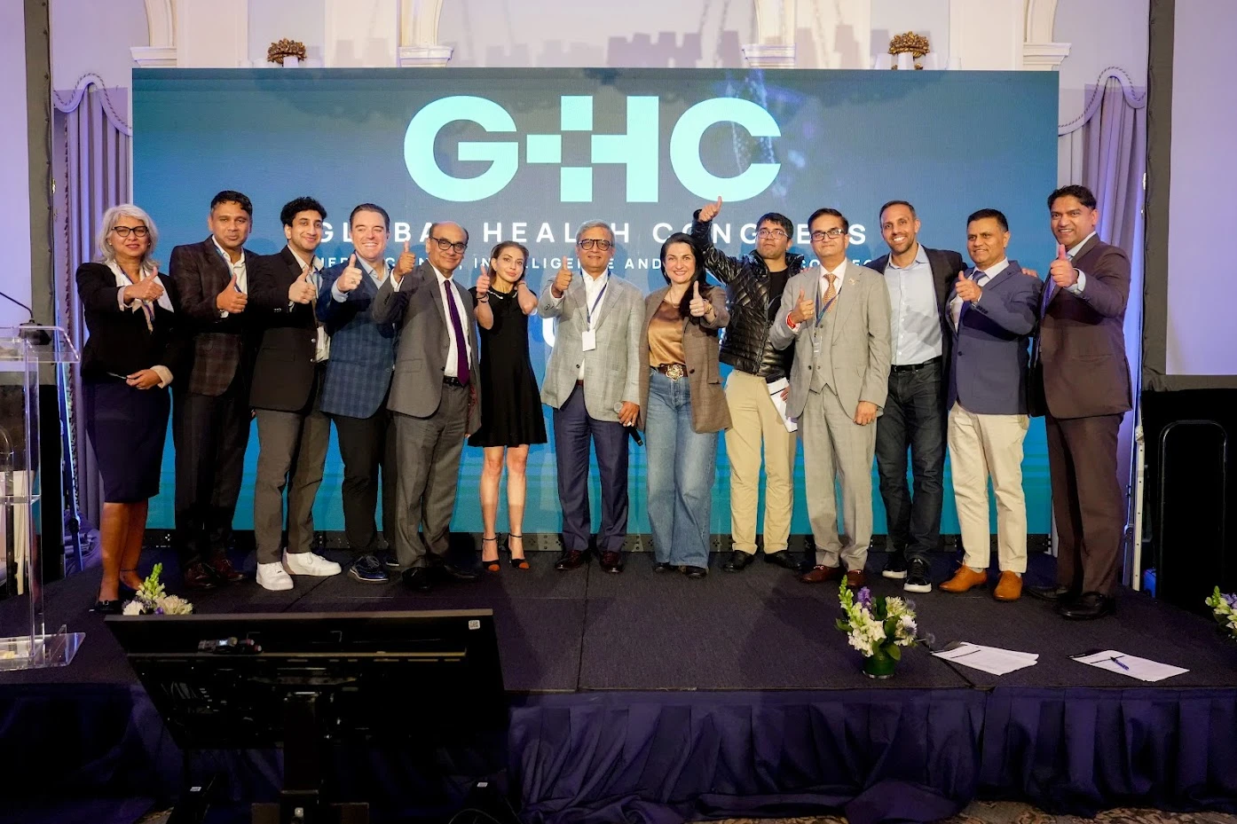 Speakers and organizers on stage at Global Health Congress 2026 at The Yale Club, New York, giving a thumbs up